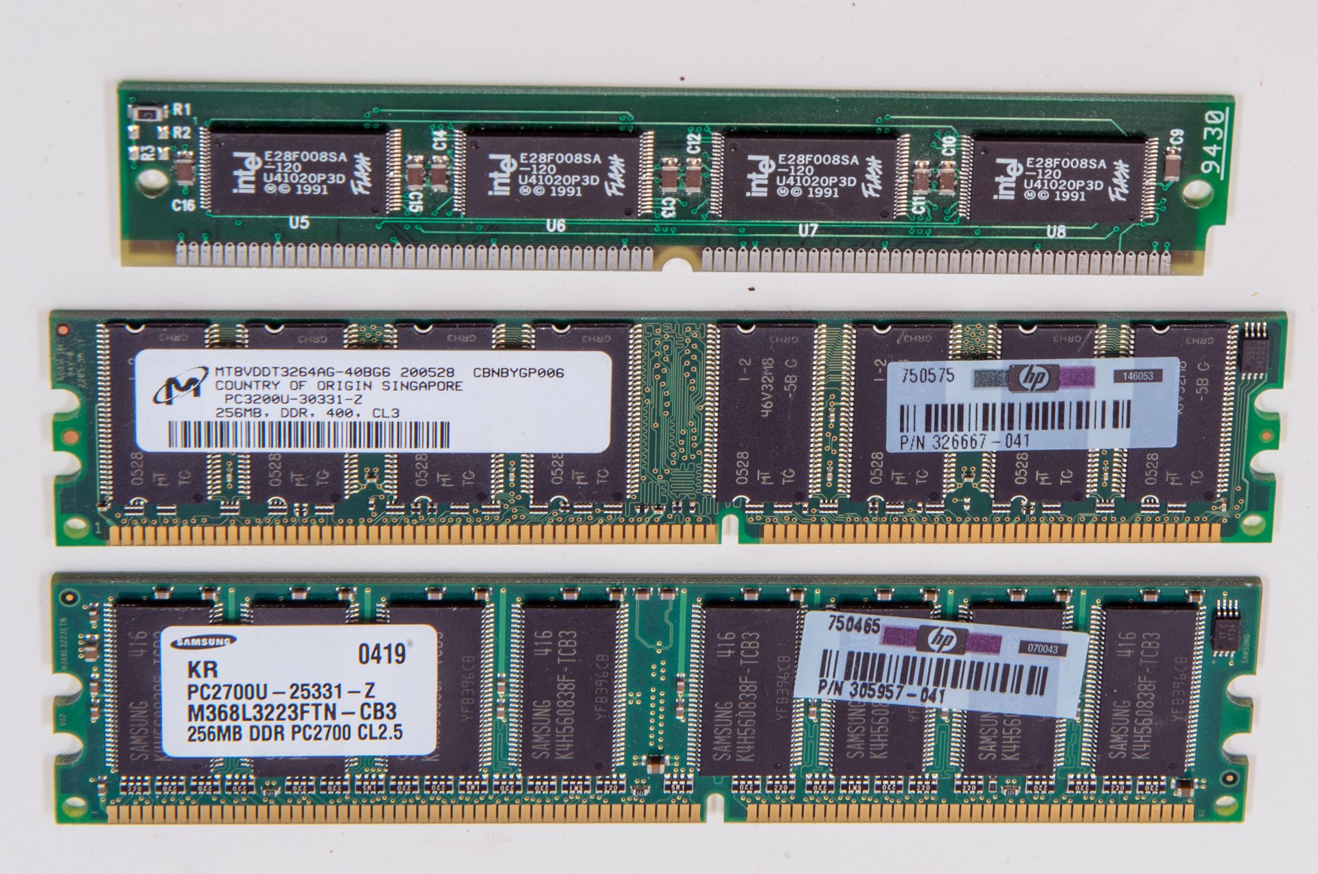Three memory circuit boards, including Intel Flash and Micron and Samsung module markings